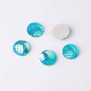 Macro view of 14mm round mermaid scale resin cabochons with AB iridescent finish and flat back