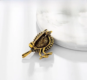 Detailed back view of vintage sparrow brooch showing the sturdy safety pin and antique metal finish