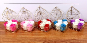 Five heart-shaped golden iron baskets with six colorful soap rose flowers each