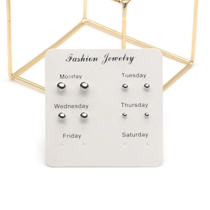 Detail of silver stud earrings set on a display card for daily fashion wear