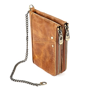 Detail of vintage brown leather long wallet featuring dual zippers and anti-theft chain