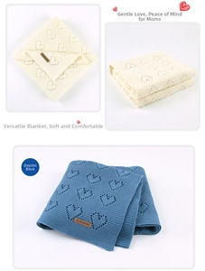 Close-up of knit baby blanket featuring heart hollow patterns and leather brand label