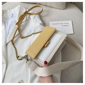 Detail of yellow flap and off-white faux leather crossbody bag with dual shoulder straps
