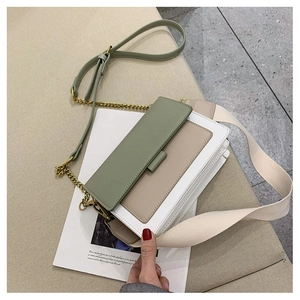 Detail of green and beige tricolor square crossbody bag with dual shoulder straps