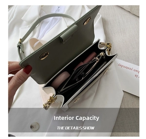 Internal view of mint green square bag showing capacity for phone and wallet
