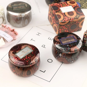 Floral tin aromatherapy candle jars with decorative gift boxes and sun flower patterns