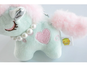 Close-up of light green plush unicorn keychain with pink mane and pearl necklace detail