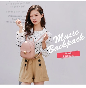 Pink PU leather mini backpack with a golden metal buckle worn by a model in outdoor light