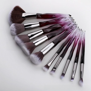 Detailed fan layout of 11 professional makeup brushes with purple crystal gradient handles