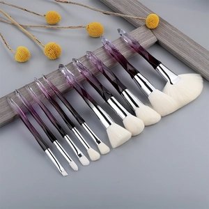 Detail of 10pcs makeup brush set with purple diamond cut handles and white bristles