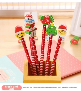 Detail of Christmas pencil set with 3D snowman and Santa erasers in a wooden pen holder