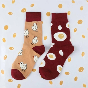 Detail view of cotton crew socks featuring cute chicken and fried egg patterns