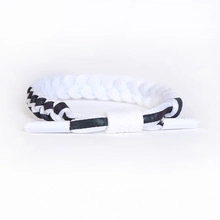Close-up of adjustable black and white woven bracelet with white sliding toggle