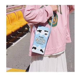 Detail of creative blue milk carton crossbody bag with cow pattern and 750ml text