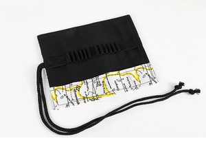 Detail view of canvas pencil wrap with vintage map print and elastic slots for art tools
