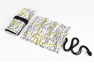 Detail view of canvas pencil roll with vintage map print and black woven tie cord