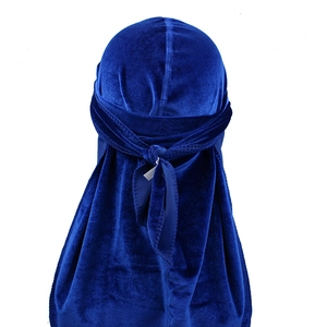 Detail view of royal blue velvet durag with extra long tails and seamless fabric texture