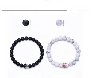 Detail showing 8mm black matte and white howlite crown distance bracelets for couples
