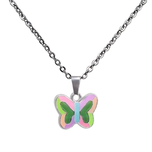 Detail of colorful butterfly pendant necklace with enamel patterns and silver link chain