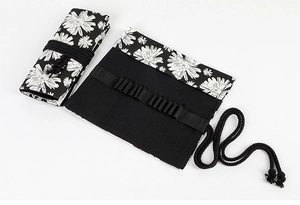Detail of floral canvas wrap case showing both rolled and unrolled storage compartments