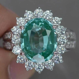 Luxury oval mint green gemstone sunflower engagement ring with sparkling pavé cubic zirconia