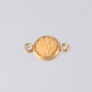 Detailed view of 10mm gold-plated stainless steel star charm connector with beige stones