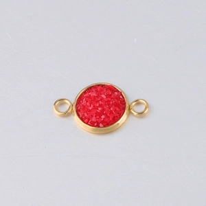 Detailed macro view of a 10mm gold-plated stainless steel connector with red stone center