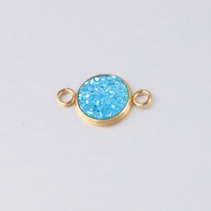 Detail of 10mm gold vacuum plated stainless steel connector with blue sparkling resin center