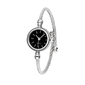 Detail of silver cable bangle quartz watch with a minimalist black round dial
