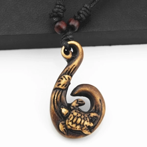Tribal Māori fish hook pendant necklace with sea turtle carving on black woven cord
