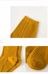 Detail view of ginger yellow ribbed cotton socks showing elastic cuff and seamless toe