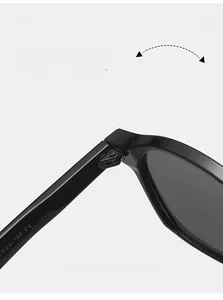 Close-up of durable metal hinge on black retro sunglasses with CE certification mark