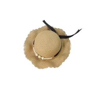 Summer straw hat for kids with wavy brim, pearl trim and elegant black ribbon tie