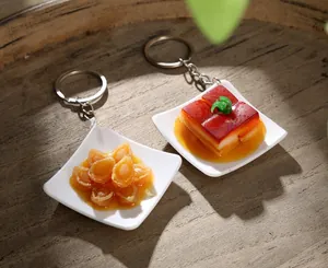 Realistic braised pork and abalone food model keychain with a mini porcelain plate
