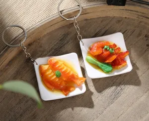Detailed view of realistic miniature food keychains with faux meat and fish on wood