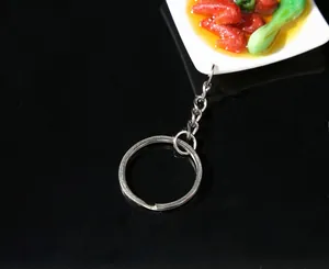 Macro shot of realistic food keychain featuring braised pork model on a white tray