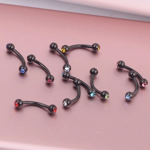 Detail of 9 black curved barbell body jewelry pieces with colorful inset crystals