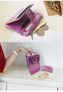 Detail of pink heart crossbody bag with open interior compartments and gold chain strap