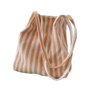 Large orange and white striped canvas tote bag with long handles and herringbone texture
