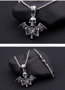 Close-up of retro silver gothic skull bat pendant on a sturdy rope chain with black stones