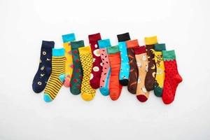 Flat lay of colorful cotton mid-calf socks with fruit, animal and stripe patterns