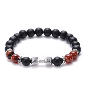 Detail of beaded gym bracelet with silver dumbbell charm and natural tiger eye stones