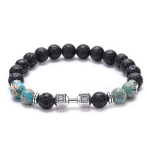 Macro detail of lava stone and turquoise beads with a silver LIVE LIFT dumbbell charm