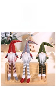 Detailed view of three festive plush Christmas gnomes in red, grey, and green colors