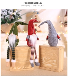 Detailed view of three festive Christmas gnomes in red, green, and gray on wood blocks