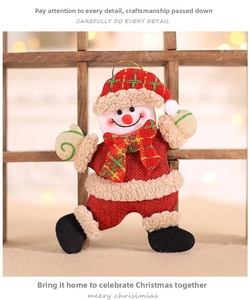 Detailed view of handmade plush Christmas snowman ornament with red burlap and plaid scarf
