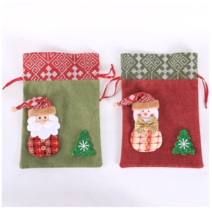 Detail of Christmas burlap drawstring gift bags with Santa and Snowman embroidery patches