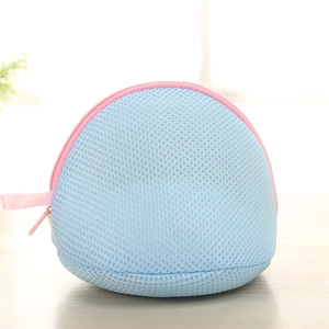 Close-up of semi-spherical blue mesh laundry bag with pink zipper for bras