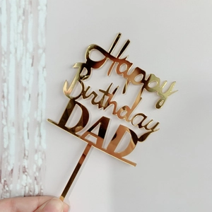Macro detail of golden mirrored acrylic cake topper with Happy Birthday DAD lettering