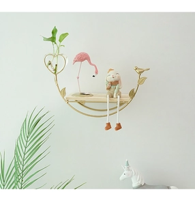 Detail of gold metal crescent wall shelf with wooden base and heart glass vase